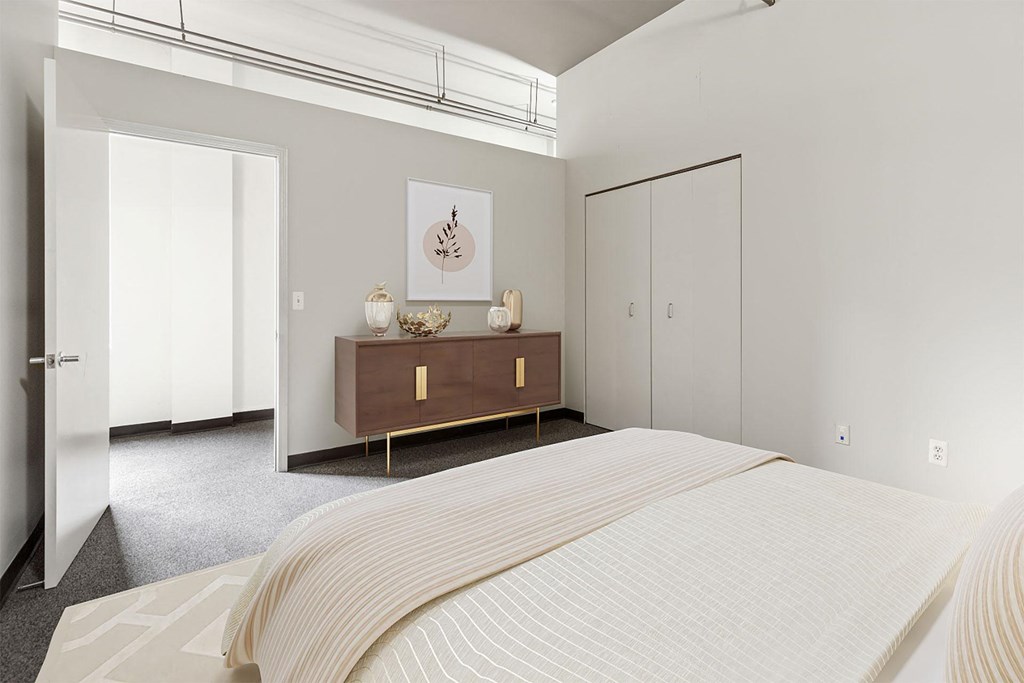 a bedroom with a bed and a dresser