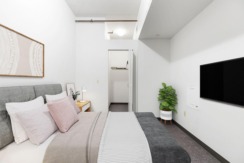 a bedroom with a bed and a tv