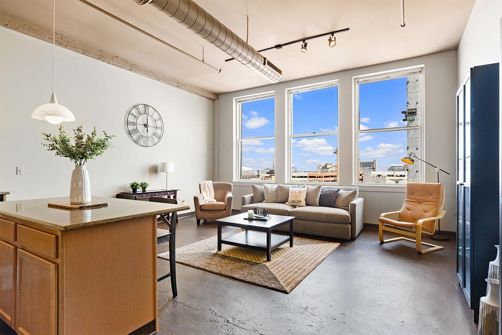 a living room with a couch and a table and a large window