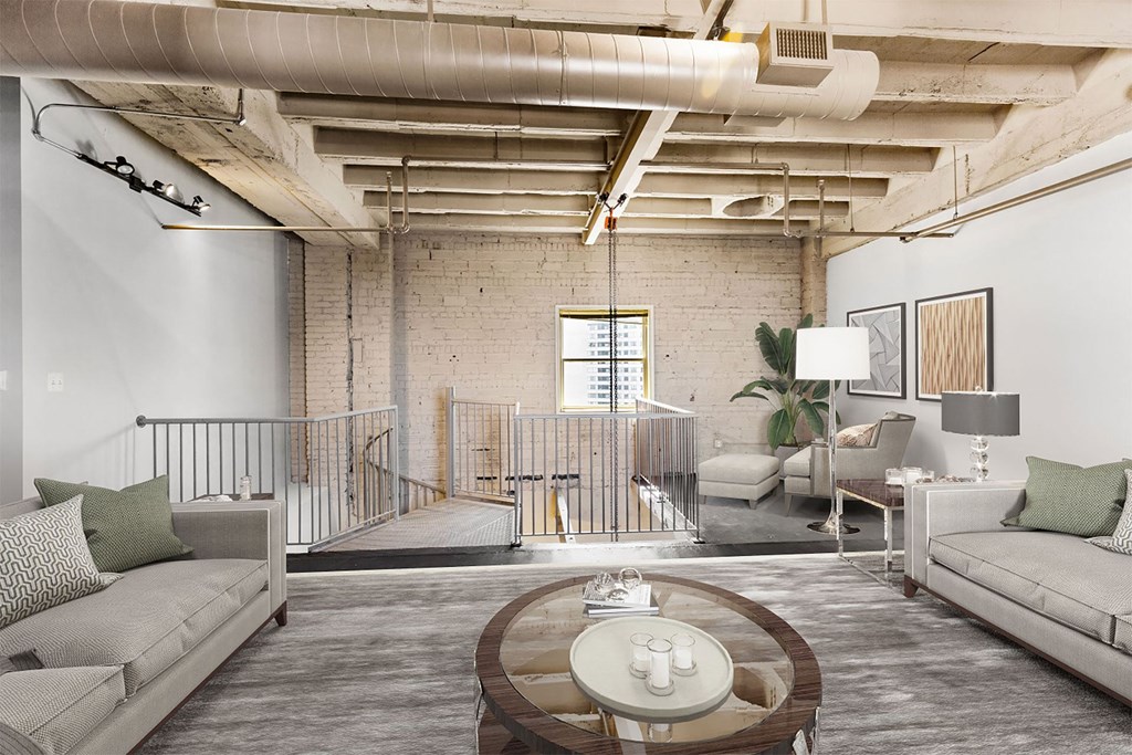 a living room with couches and a coffee table in a loft