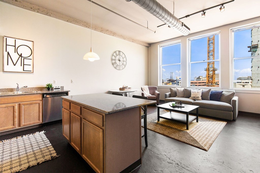 an open living room with a kitchen and a view of the city
