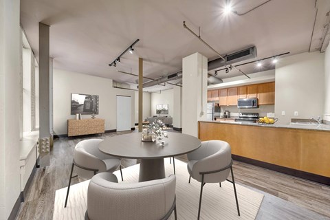 A modern dining room with a round table and chairs.