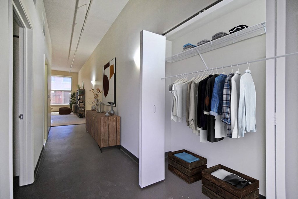 the walk in closet in the master bedroom is filled with closets and a wardrobe