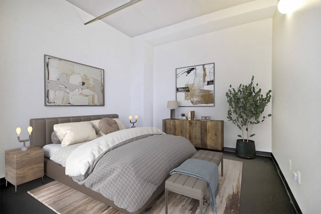 a bedroom with a bed and some pictures on the wall