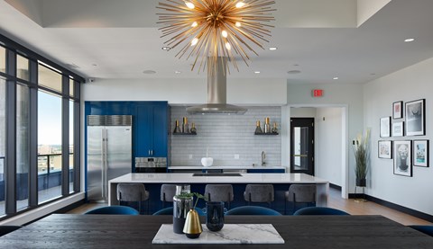 A modern kitchen with a large island and a dining area.