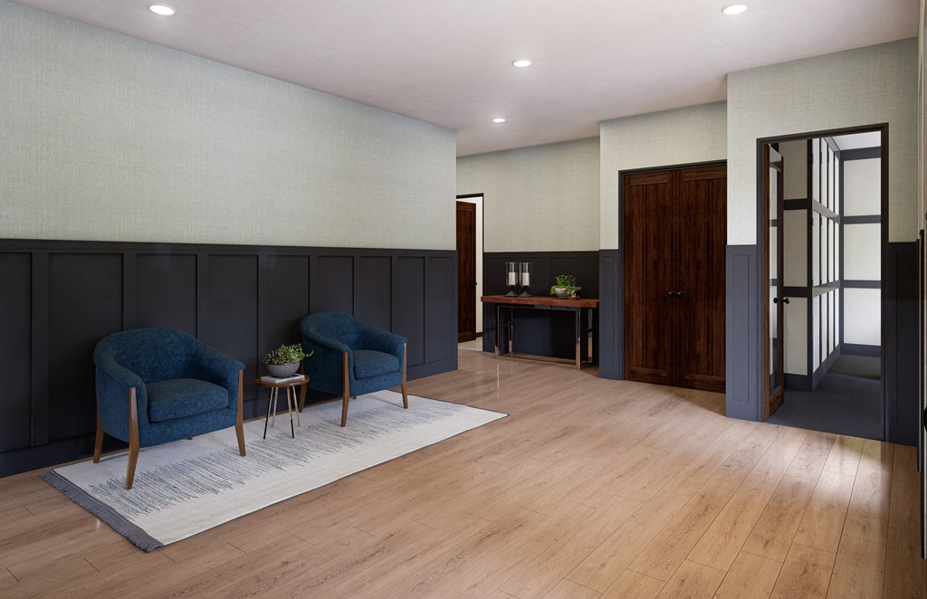 a living room with two blue chairs and a rug