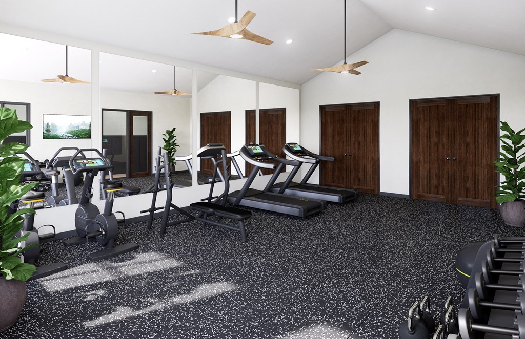 a gym with treadmills and other exercise equipment in a building with white walls