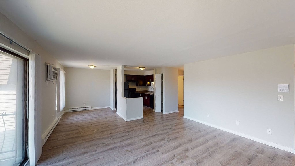 a living room and dining room with a wood floor