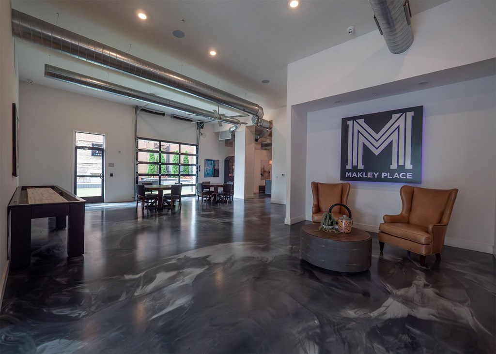 A large room with a marble floor and a sign that says Makley Place.