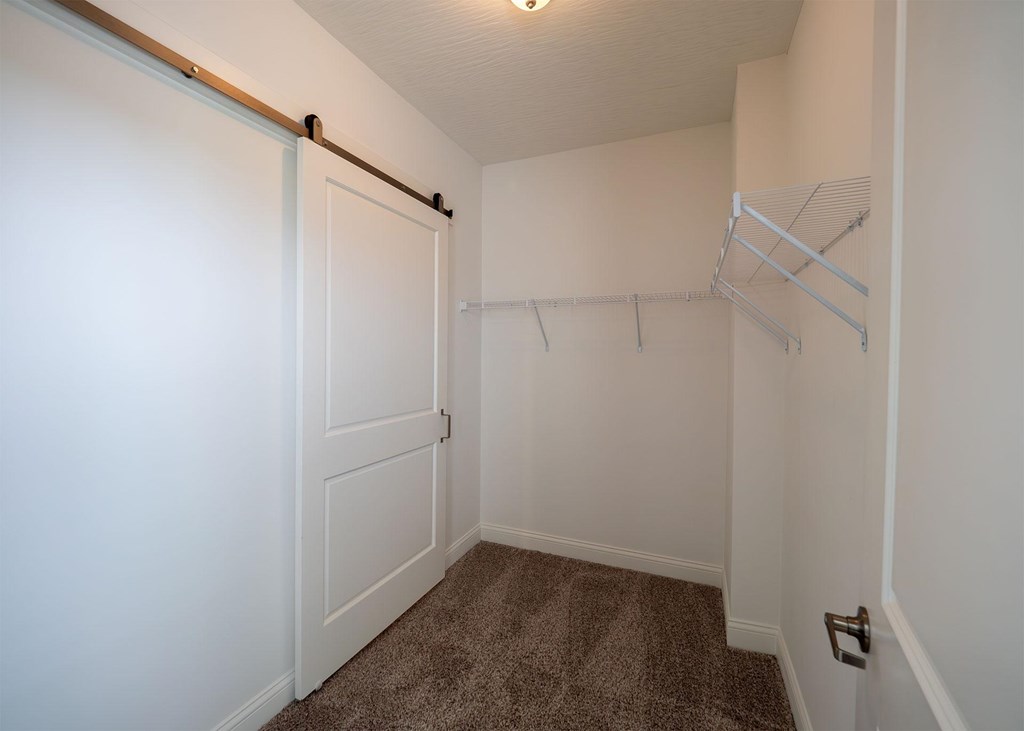 A white door with a handle and a white wall.