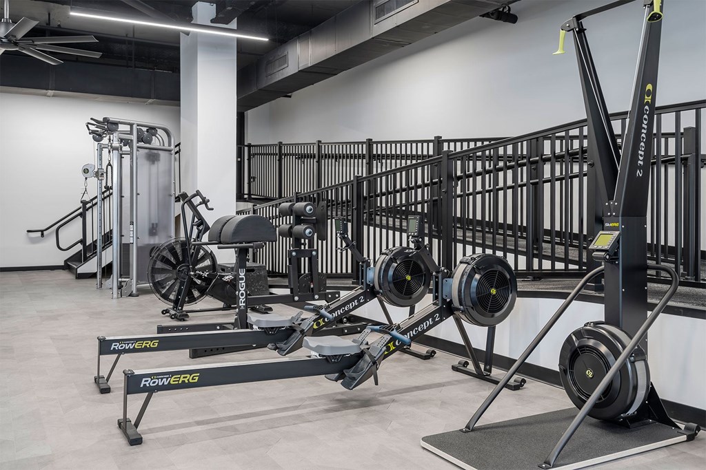 A gym with a white wall and a black floor.