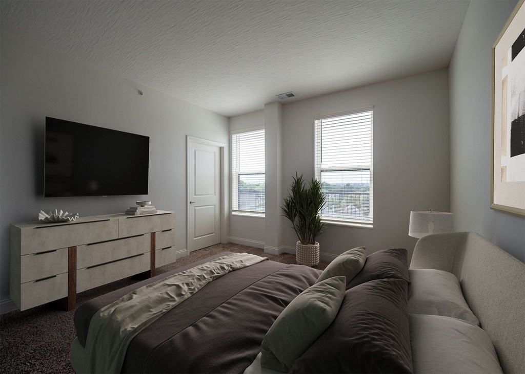 A modern bedroom with a large bed and a flat screen TV.