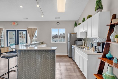 A kitchen with a bar area and a chair.