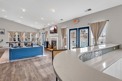 A living room with a blue couch and a white counter.