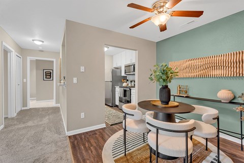A dining room with a table set for four.