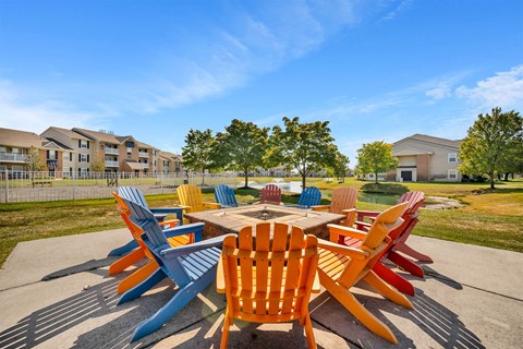 A large table surrounded by chairs in a courtyard.