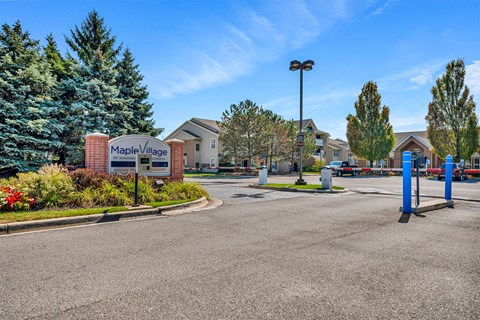 Maple Village residential area with a sign and houses.