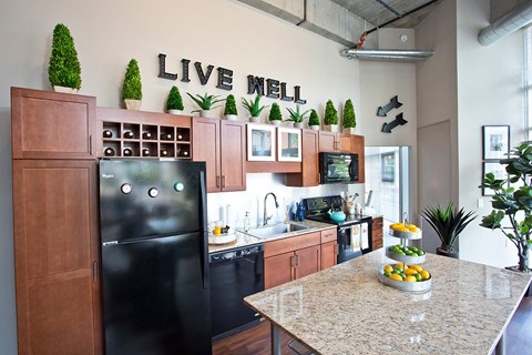 a kitchen with black appliances and a counter top
