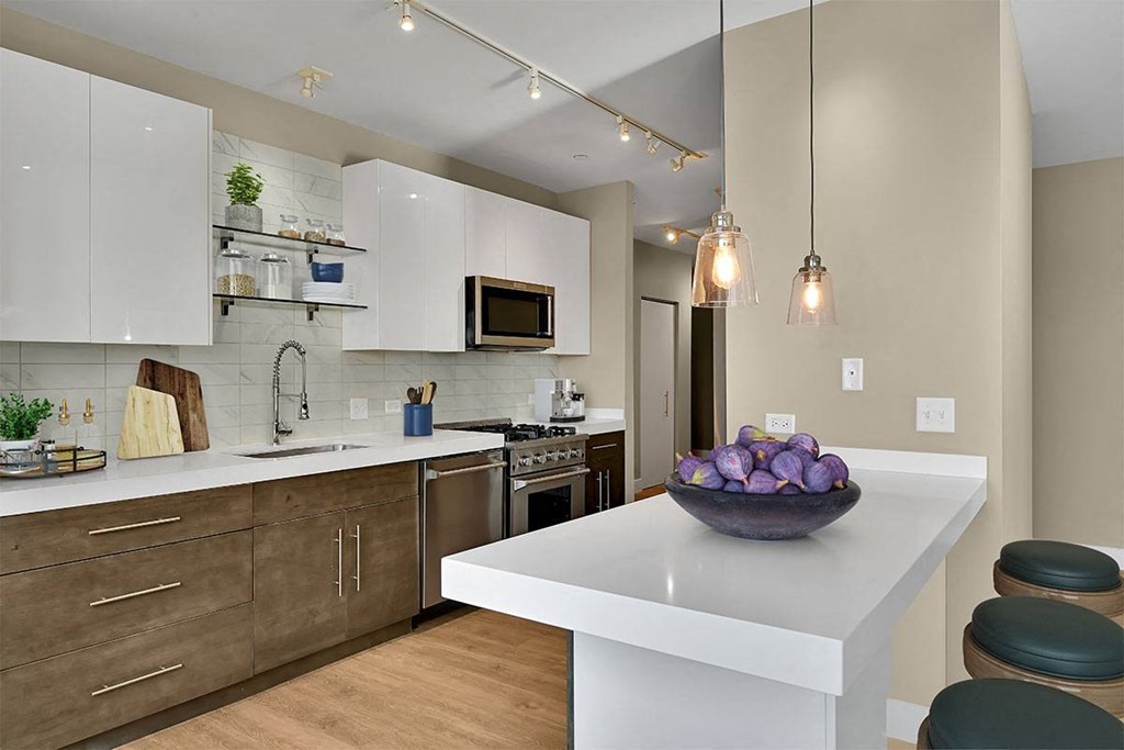 a kitchen with a bowl of fruit on the counter
