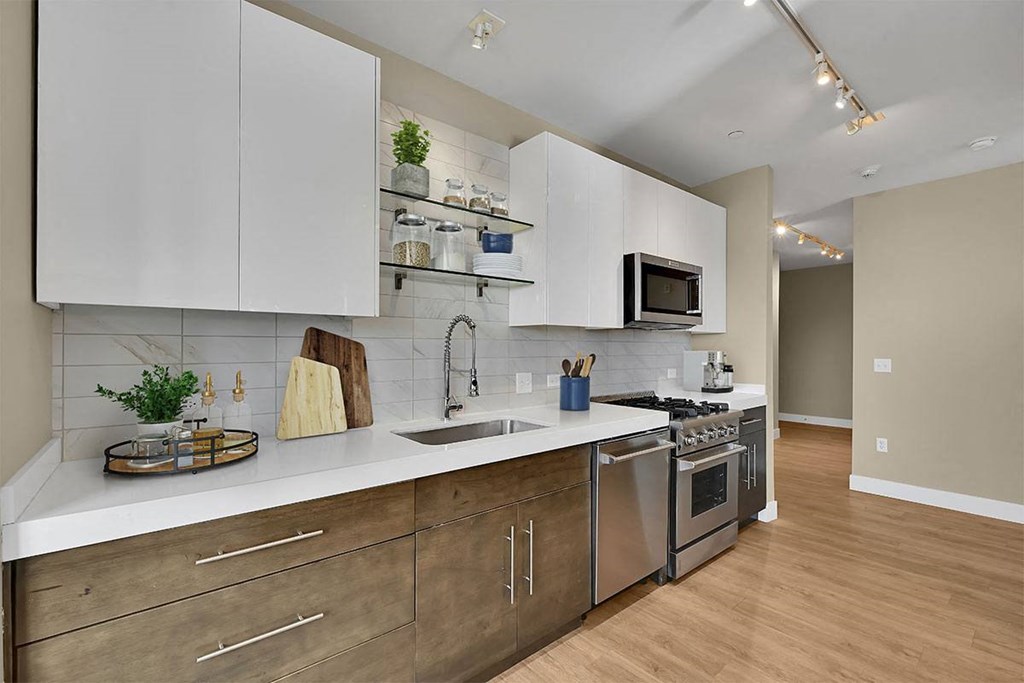 a kitchen with stainless steel appliances and white cabinets