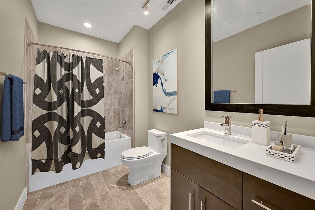 a bathroom with a shower toilet and sink