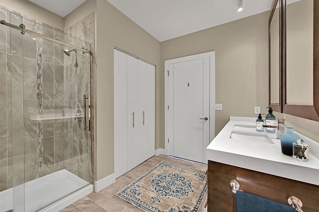 a bathroom with a shower and a sink