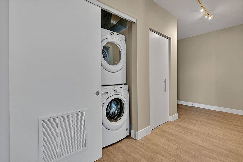 a washer and dryer in a closet with a door