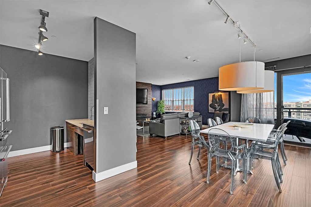 a dining room and living room with a table and chairs