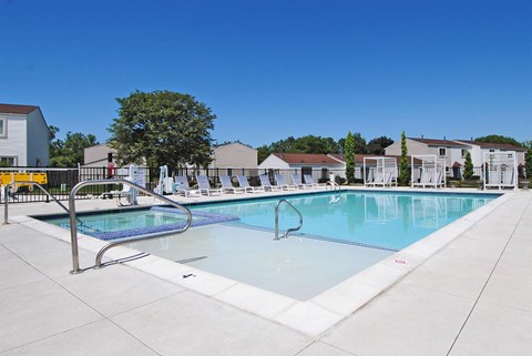 our apartments have a resort style pool with chairs around it
