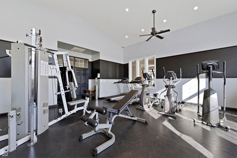 A spacious home gym with a variety of exercise equipment.