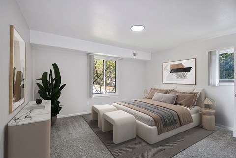 A bedroom with a large bed and a plant.