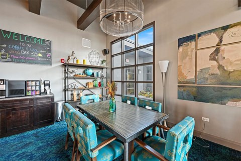 A dining room with a wooden table and blue chairs.