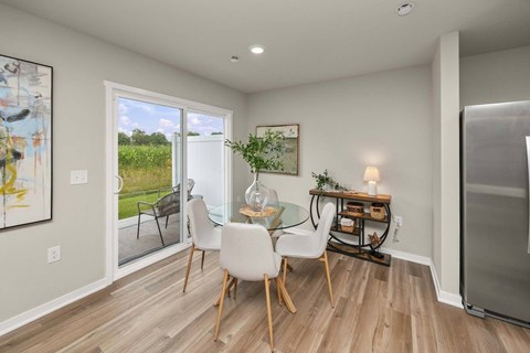 A dining room with a glass table and chairs.