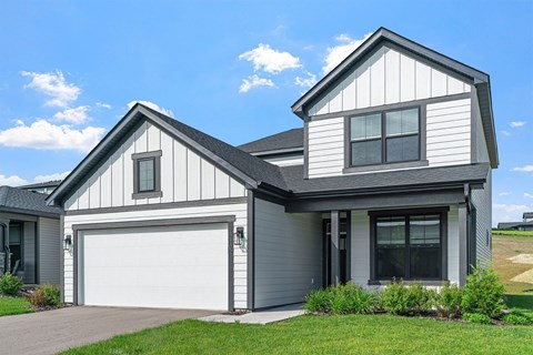 A two-story house with a garage on the ground floor.