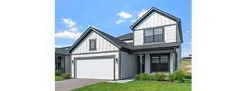 A two-story house with a garage on the ground floor.