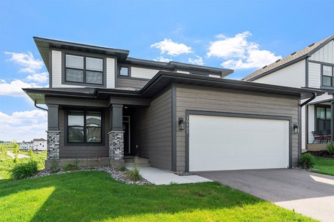 A modern house with a grey garage door.