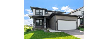 A modern house with a grey garage door.