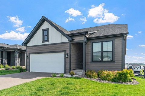 A house with a garage door and a driveway.