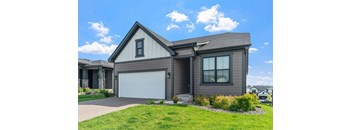 A house with a garage door and a driveway.