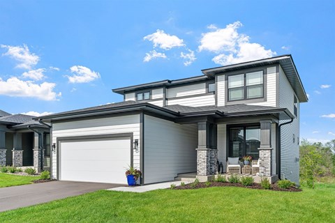 A modern house with a grey garage door and a white interior.