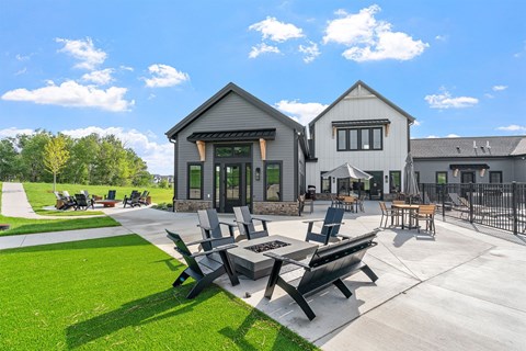 A sunny day at a park with a picnic table and chairs.