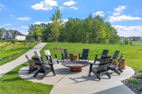 A set of chairs and tables are arranged in a circle on a patio.