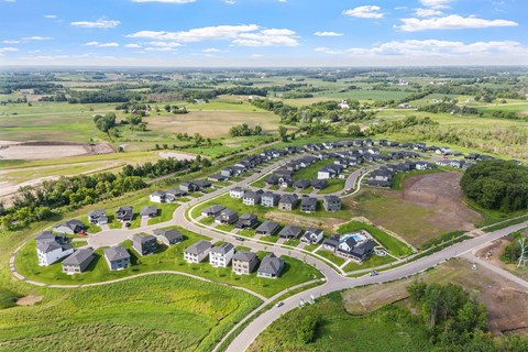 A bird's eye view of a residential area with houses and roads.