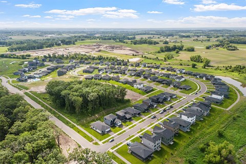 A bird's eye view of a residential area with houses and greenery.