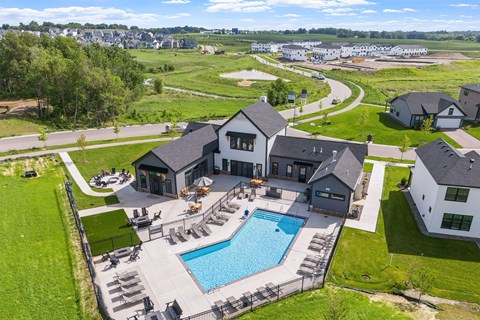 A large house with a pool in the backyard.