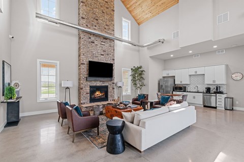 A modern living room with a stone fireplace and a large sectional sofa.