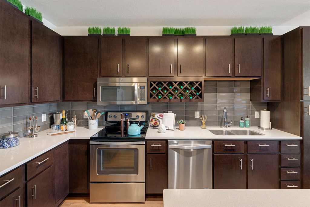 a modern kitchen with stainless steel appliances and wooden cabinets