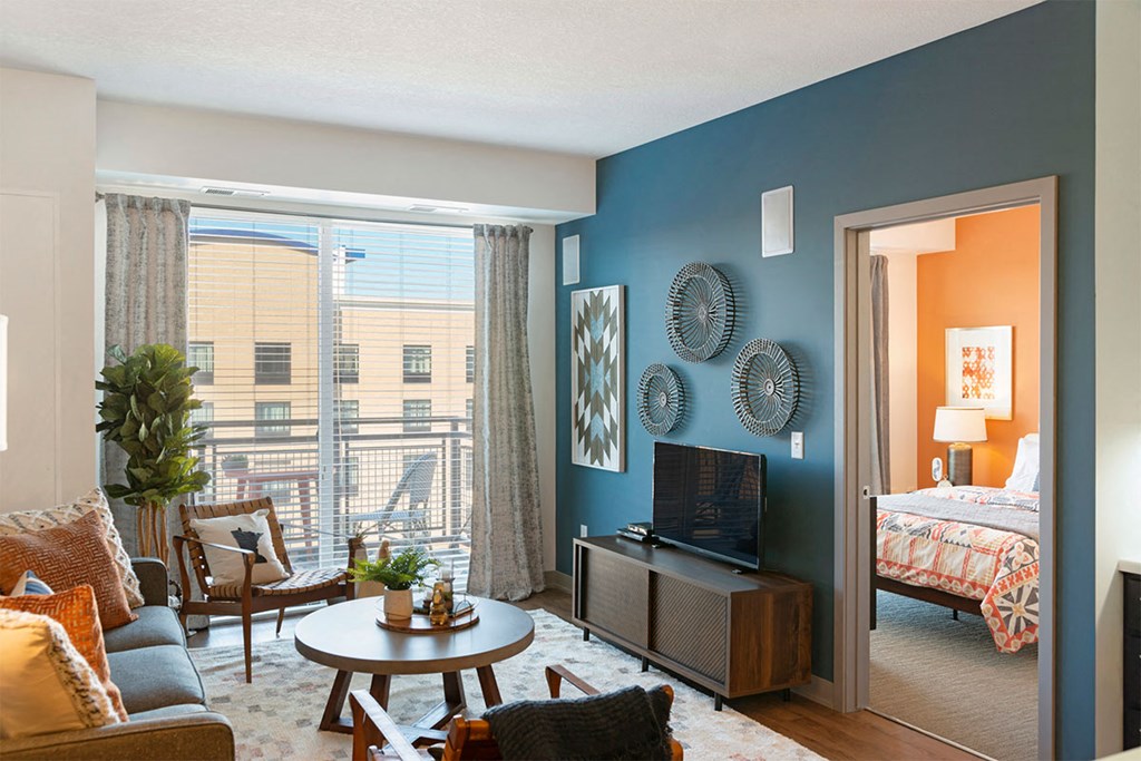 a living room with a view of a bedroom and a tv