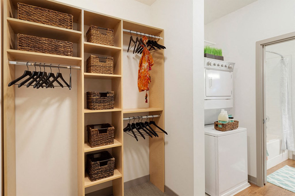 a laundry room with a closet and a washer and dryer