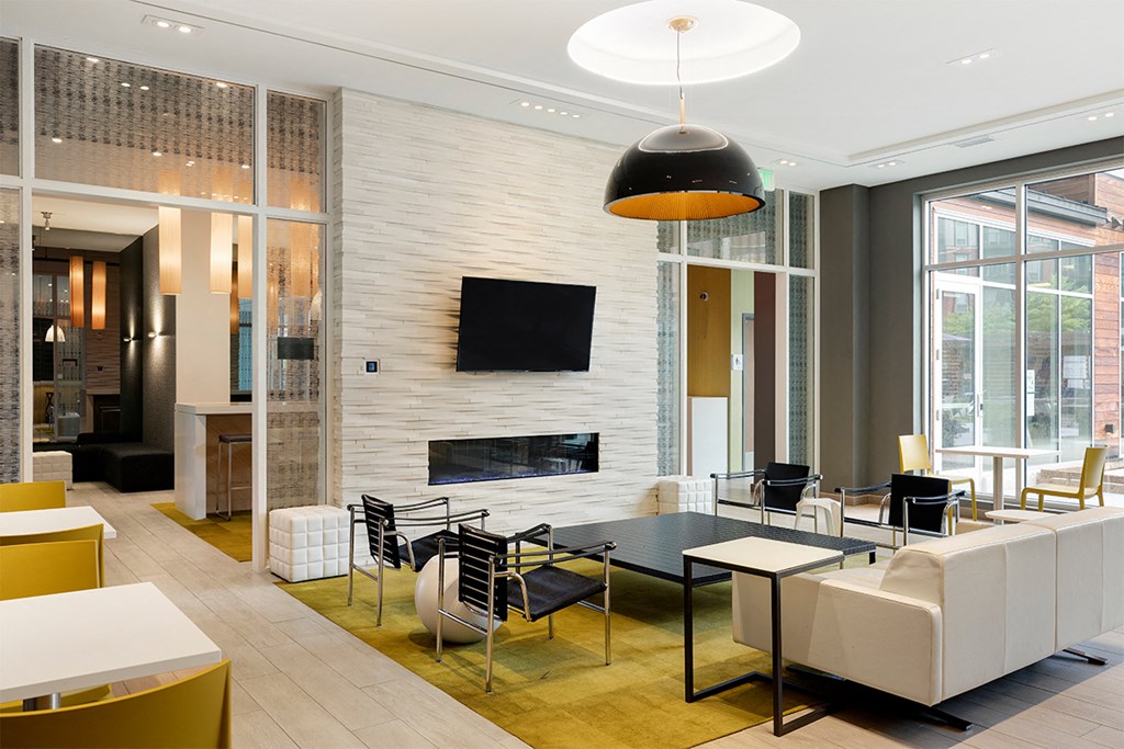 a living room with a table and chairs and a fireplace